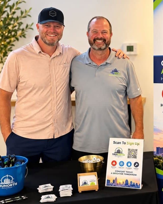 Jeff Wilp and Rusty Meyer, owners of TruNorth Mechanical, standing together at a community event booth